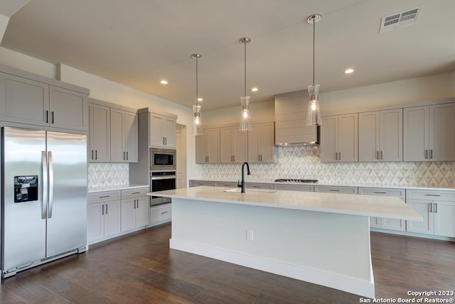 kitchen featuring visible vents, appliances with stainless steel finishes, gray cabinets, light countertops, and a sink