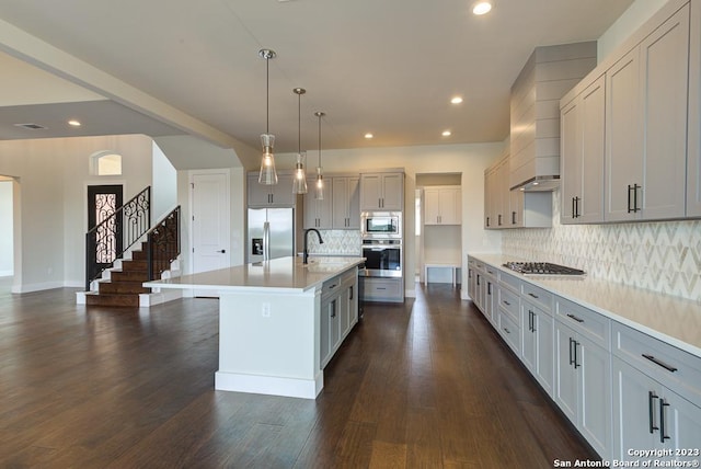 kitchen with recessed lighting, stainless steel appliances, light countertops, decorative backsplash, and dark wood-style floors