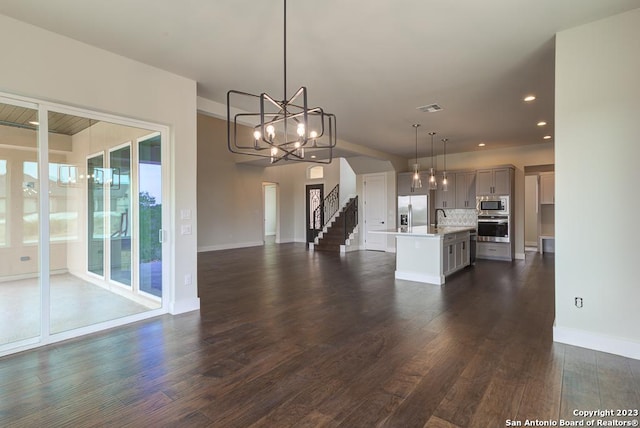 kitchen with visible vents, open floor plan, an inviting chandelier, stainless steel appliances, and light countertops