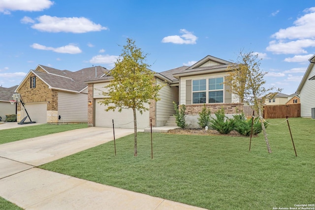 view of front of property with a garage, concrete driveway, fence, a front lawn, and brick siding