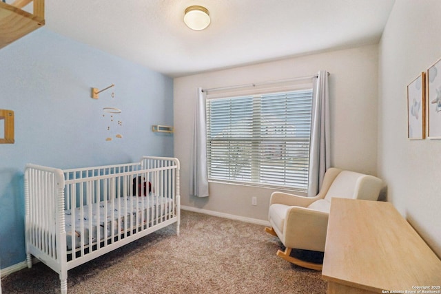 bedroom with carpet, a crib, and baseboards