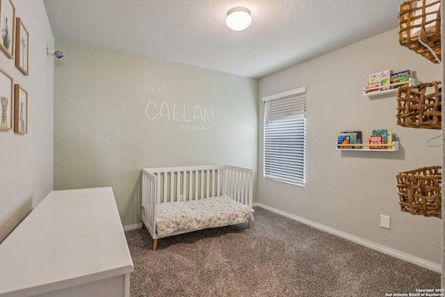 carpeted bedroom featuring baseboards and a textured ceiling