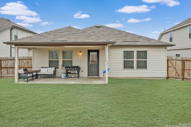 rear view of house with outdoor lounge area, a lawn, a patio area, and fence