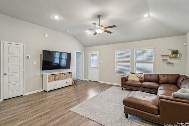 living room with baseboards, a ceiling fan, wood finished floors, vaulted ceiling, and recessed lighting