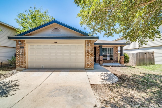 ranch-style house featuring a garage, driveway, brick siding, and fence