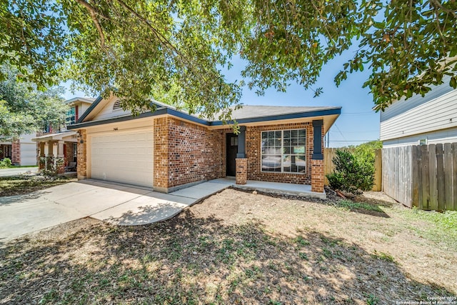 single story home featuring concrete driveway, brick siding, fence, and an attached garage