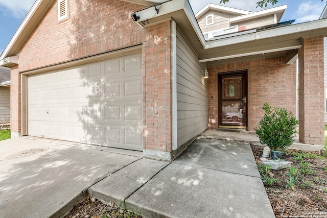 entrance to property with brick siding and driveway