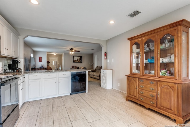 215 Quince Flower, San Antonio, TX 78253 - kitchen with visible vents, white cabinets, open floor plan, a peninsula, and black appliances