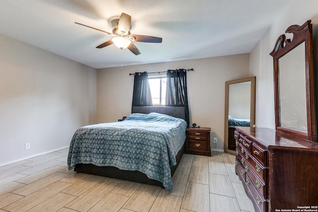 215 Quince Flower, San Antonio, TX 78253 - bedroom with wood tiled floor, baseboards, ceiling fan, and a textured ceiling