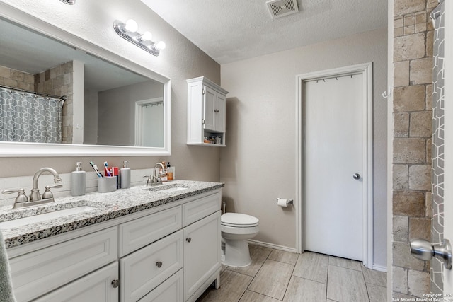 215 Quince Flower, San Antonio, TX 78253 - full bath featuring toilet, double vanity, a sink, and visible vents