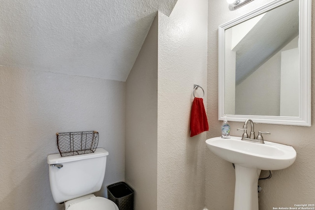 215 Quince Flower, San Antonio, TX 78253 - bathroom with a textured wall, vaulted ceiling, a textured ceiling, and toilet