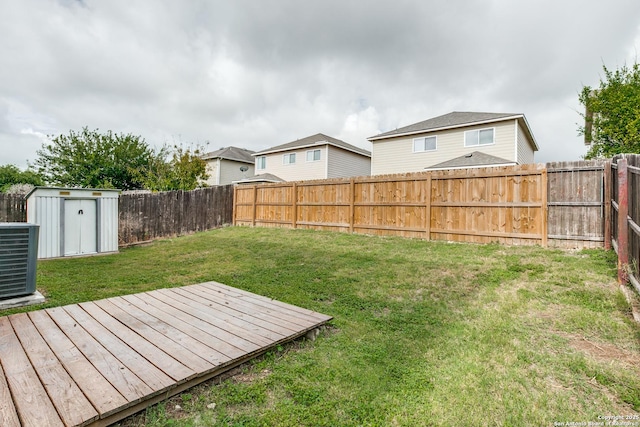215 Quince Flower, San Antonio, TX 78253 - view of yard with a storage shed, central AC unit, a fenced backyard, an outbuilding, and a deck