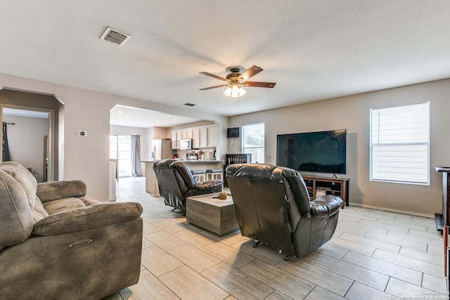 215 Quince Flower, San Antonio, TX 78253 - living room featuring ceiling fan, a wealth of natural light, a textured ceiling, and visible vents