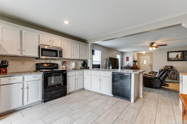 215 Quince Flower, San Antonio, TX 78253 - kitchen featuring open floor plan, black appliances, tasteful backsplash, and a peninsula