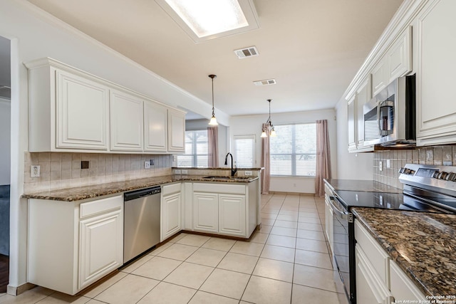 kitchen with light tile patterned floors, appliances with stainless steel finishes, a sink, and visible vents