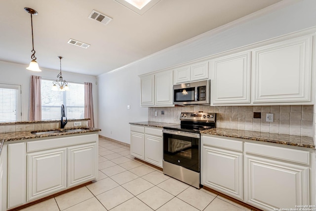 kitchen with visible vents, appliances with stainless steel finishes, decorative backsplash, and a sink