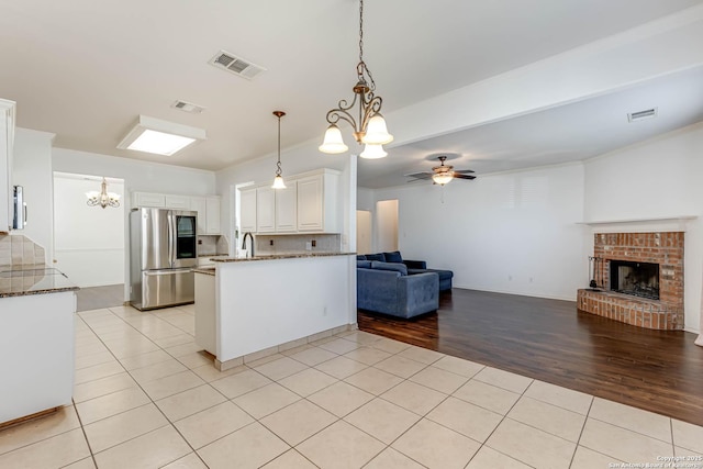 kitchen featuring visible vents, appliances with stainless steel finishes, open floor plan, and light tile patterned flooring