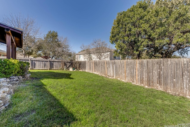 view of yard with a fenced backyard