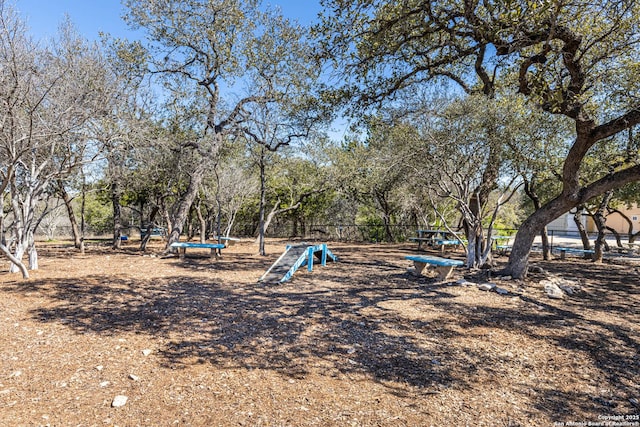 view of community featuring fence