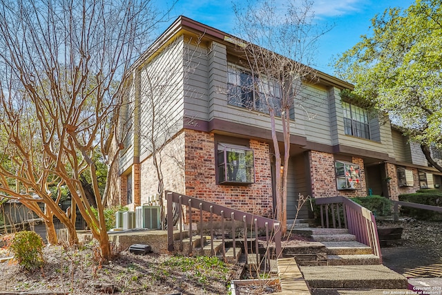 multi unit property featuring brick siding and cooling unit