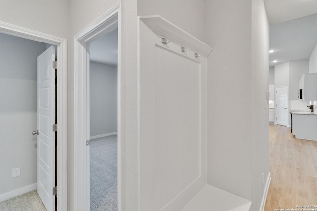 mudroom with light wood-style flooring and baseboards