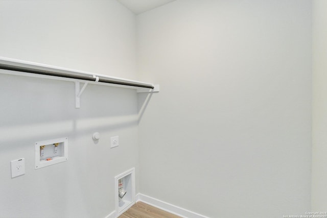 laundry area with laundry area, hookup for a gas dryer, light wood-style flooring, hookup for an electric dryer, and washer hookup