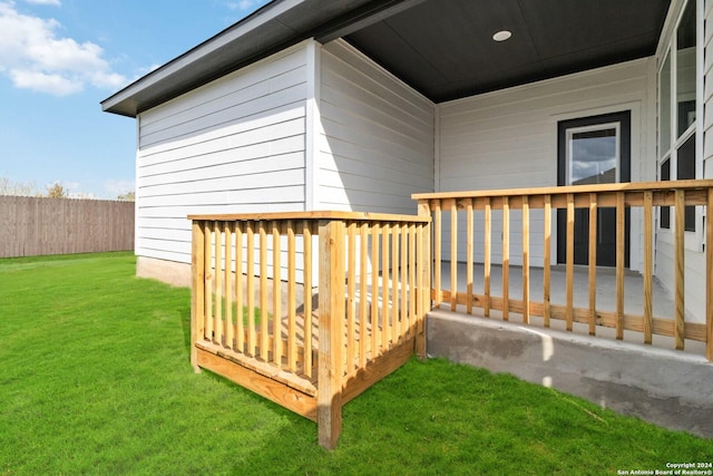 exterior space featuring fence and a lawn