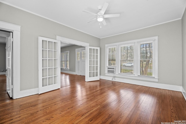 spare room featuring ornamental molding, ceiling fan, baseboards, and hardwood / wood-style flooring