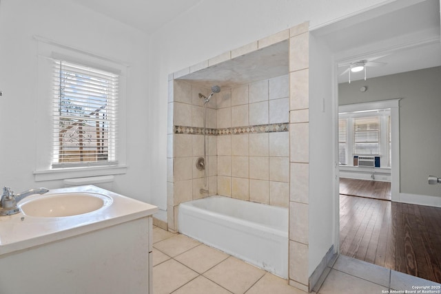 full bathroom with baseboards, a ceiling fan, tile patterned flooring, cooling unit, and washtub / shower combination