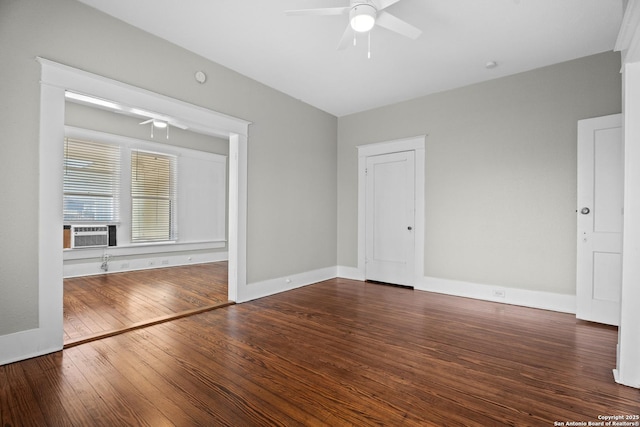 unfurnished room featuring cooling unit, wood-type flooring, ceiling fan, and baseboards