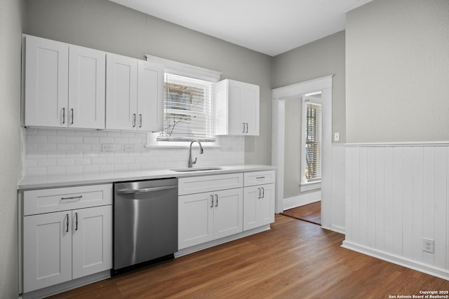 kitchen featuring dishwasher, dark wood-style flooring, a sink, and a wealth of natural light