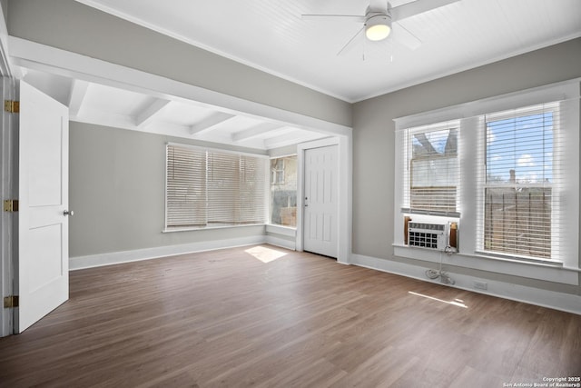 empty room featuring ceiling fan, cooling unit, wood finished floors, baseboards, and beam ceiling