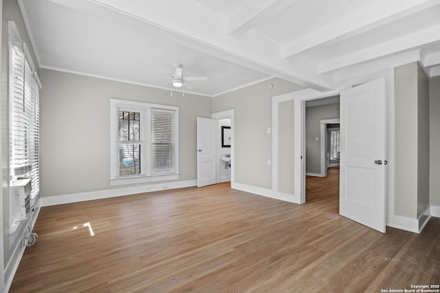 interior space with crown molding, baseboards, and wood finished floors