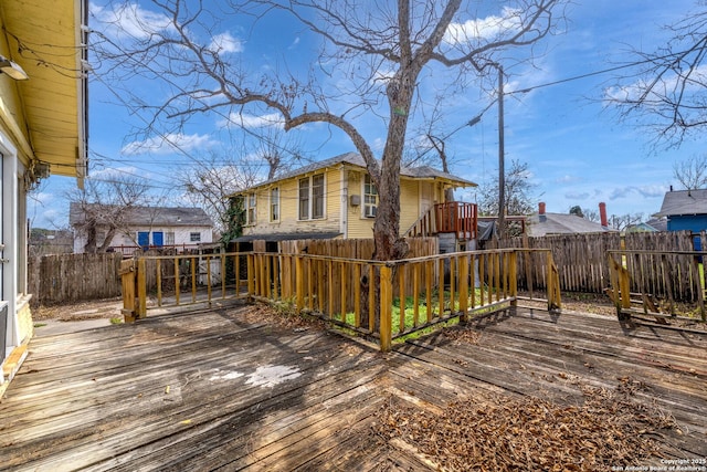 wooden terrace featuring a fenced backyard