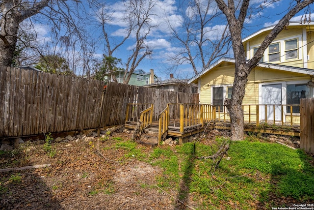 view of yard with a fenced backyard and a deck