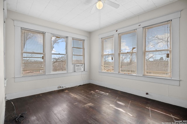 unfurnished sunroom featuring a ceiling fan