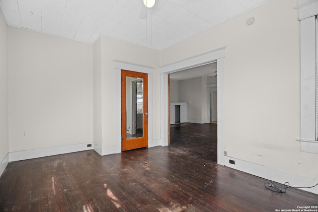 unfurnished room with hardwood / wood-style flooring and baseboards