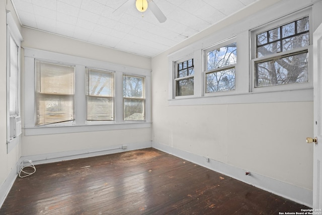 unfurnished sunroom with ceiling fan