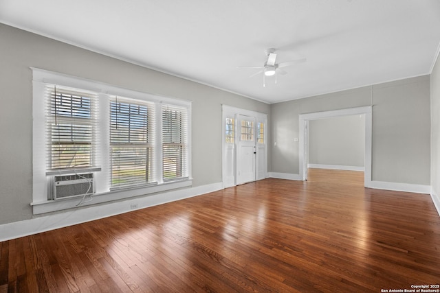 unfurnished room with ceiling fan, cooling unit, baseboards, wood-type flooring, and crown molding