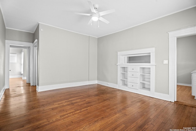 interior space featuring built in features, baseboards, ceiling fan, ornamental molding, and hardwood / wood-style floors