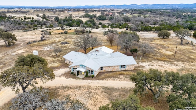 drone / aerial view featuring view of desert, a mountain view, and a rural view