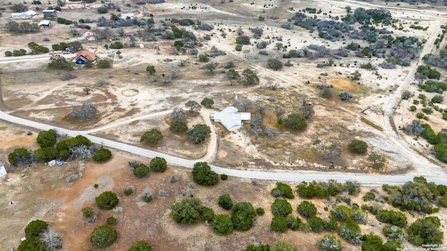 drone / aerial view featuring a rural view and view of desert