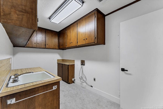 laundry room featuring light carpet, cabinet space, baseboards, washer hookup, and a sink