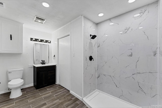 full bath with a walk in shower, toilet, wood finish floors, visible vents, and vanity