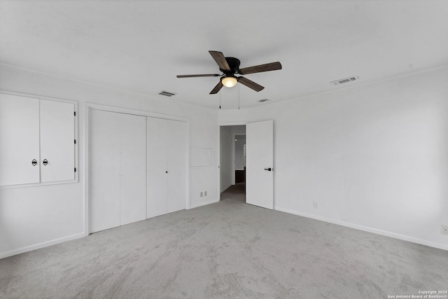 unfurnished bedroom featuring carpet floors, visible vents, ceiling fan, and baseboards