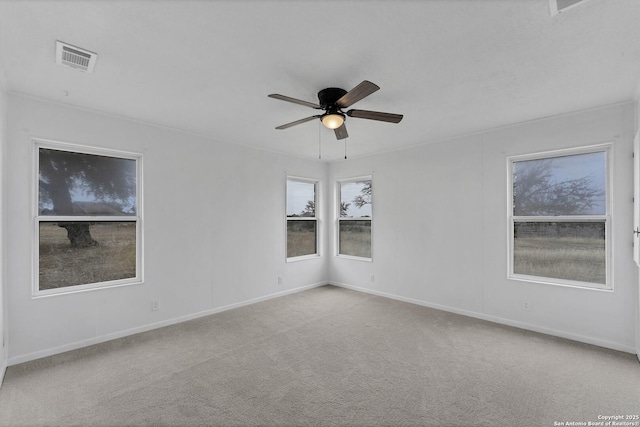 unfurnished room with ceiling fan, carpet, visible vents, and baseboards