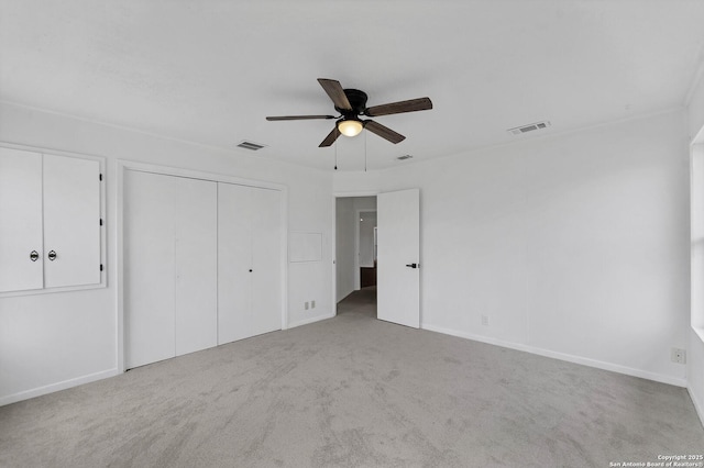 unfurnished bedroom with ceiling fan, carpet, visible vents, and baseboards