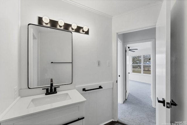 bathroom with ornamental molding, ceiling fan, and vanity