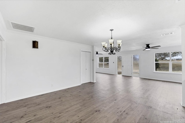 interior space featuring a healthy amount of sunlight, visible vents, and wood finished floors