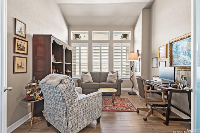 office featuring wood tiled floor, a textured ceiling, and baseboards